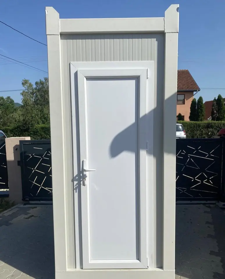 White VIP restroom cabin with a full-size door